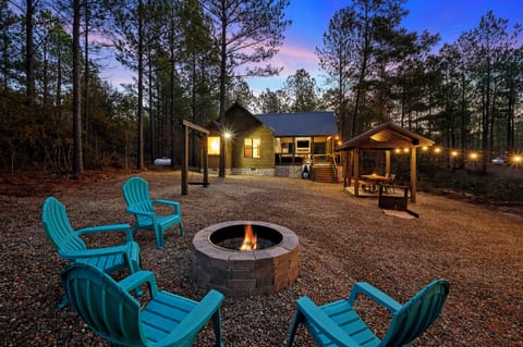 Enjoy serene evenings around the fire pit with family or friends at the Early Bird. The soft glow of string lights enhances the peaceful forest setting.