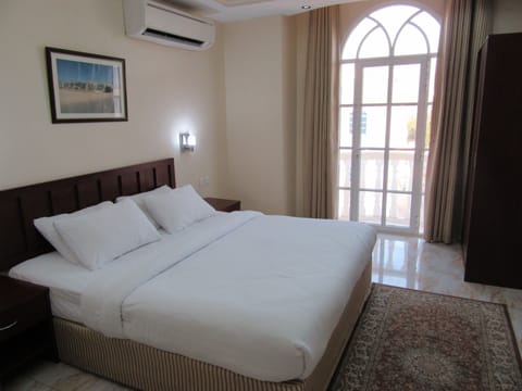 Family Apartment, 1 King Bed, City View | 1 bedroom, in-room safe, desk, iron/ironing board (on request)