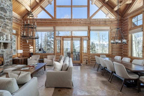 The great room at Bear Lodge features floor to ceiling mountain views and a spacious yet cozy vibe