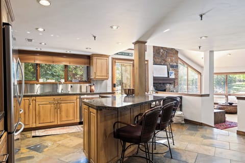 - Open kitchen with breakfast bar and lodge inspired style  
- Natural wood cabinetry and stainless steel appliances  
- Bright space connected to living room for easy gatherings