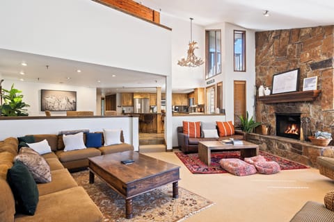 - Open living space with fireplace and lodge style decor  
- Comfortable sofas and rustic details for cozy gatherings  
- Connected layout with kitchen and dining for group stays