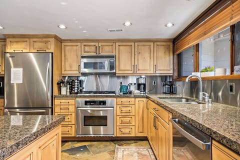 - Kitchen with modern stainless steel and wooden cabinetry  
- Ample counter space with oven, microwave, and coffee maker  
- Convenient setup for preparing group meals and snacks