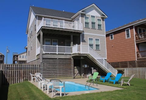 Backyard of Beach Bound & Down Featuring a Custom Concrete Pool