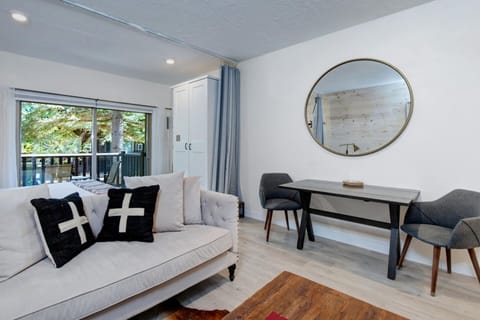 Sink into the plush sofa and let natural light pour through the glass door, opening onto your private balcony. This bright, modern space invites you to unwind and feel right at home.