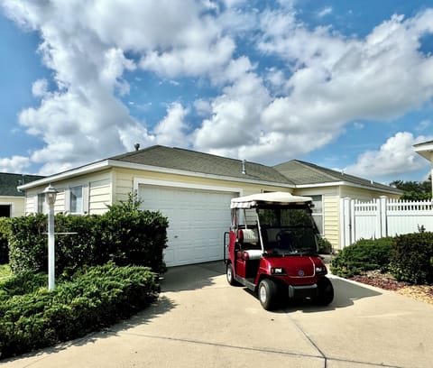 House Front with 4-Seater Golf Cart for Guest Use