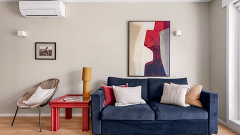 A cozy couch sits at the heart of the living room, perfect for relaxing after a day of exploring. The open, airy ambiance makes this the perfect spot to unwind. #relax #airbnb