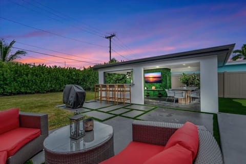 Experience the warmth of the backyard at night, with a covered patio and soft lighting for the perfect evening