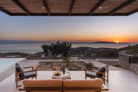 Οutdoor sitting area under a shaded pergola, to enjoy the unobstructed sea views