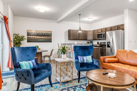 The bright open-concept main level connects comfortable living-room seating with the dining area and full kitchen.