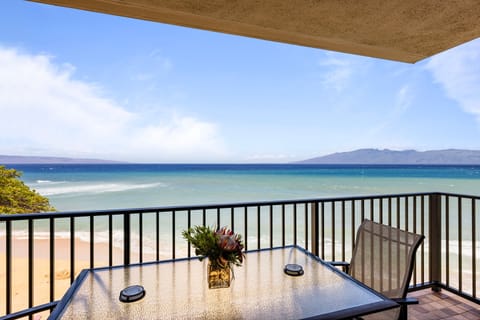 Enjoy breakfast or dinner while soaking in the view of the ocean from this spacious dining balcony, ideal for outdoor meals with a cool sea breeze.