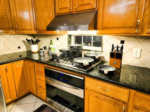 Modern kitchen, gourmet stove, oven, oils, knives, utensils at your exposal.

