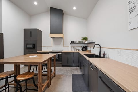 The kitchen features modern appliances, including a microwave, refrigerator, and dishwasher, making meal prep and cleanup a breeze
