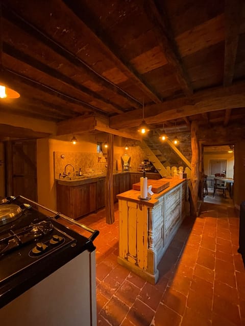 Spacious kitchen with wooden bar in a holiday cottage close to Dinant and Durbuy. Perfect for cooking and sharing moments together.