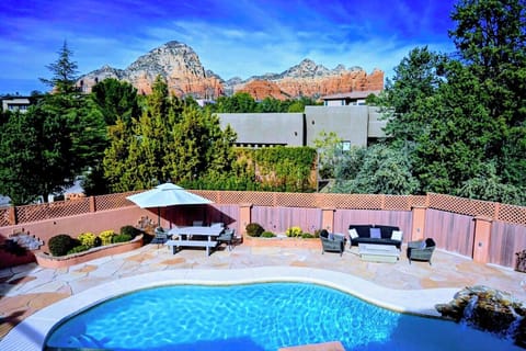 Living space deck with firepit overlooking pool and Thunder Mountain