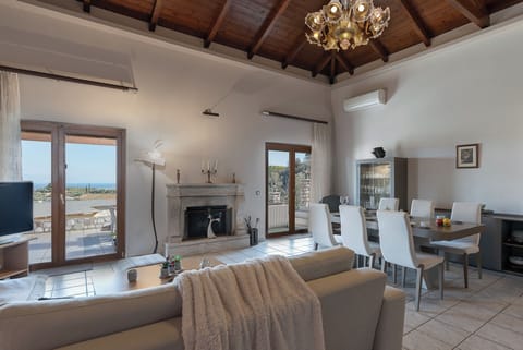 Superior Villa, Sea View | Living room | Flat-screen TV, fireplace