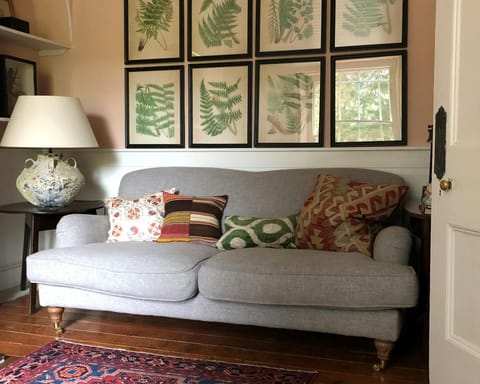 Sofa with cushions and a side table and lamp