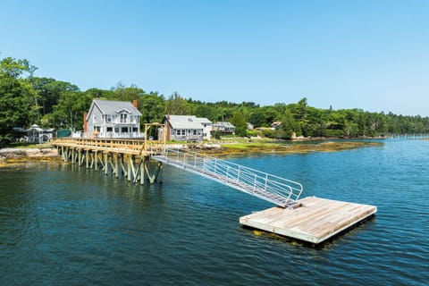 This seaside home comes with a dock for fishing or sitting by the sea.
