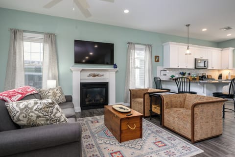 Open concept living room with queen pull out sofa and fireplace.