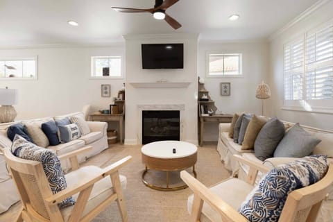Living Room with two comfortable couches, two lounge chairs, smart tv and fireplace