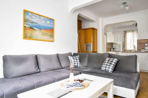 Bright living room with a comfy sofa, perfect for unwinding. Want to hear more about this space? Drop us a line!