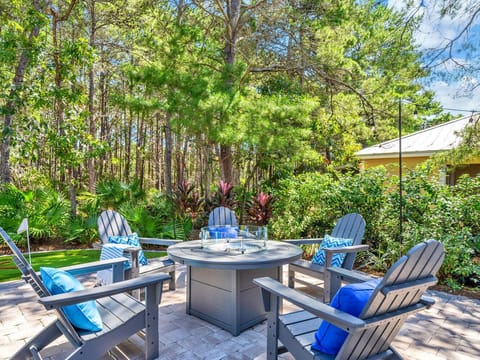 Gather around your private fire pit with comfortable Adirondack chairs, surrounded by tropical landscaping for perfect evening conversations.