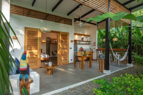 Exterior view of open-air villa with terrace and jungle surroundings at Tres Lodge Tucan, Playa Chiquita, Costa Rica