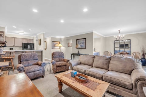 Living Room: Couch w/pull out bed, 2 recliners, gas fireplace, 65” Smart TV, access to balcony
