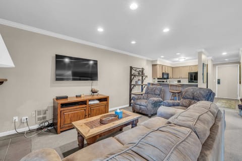 Living Room: Couch w/pull out bed, 2 recliners, gas fireplace, 65” Smart TV, access to balcony
