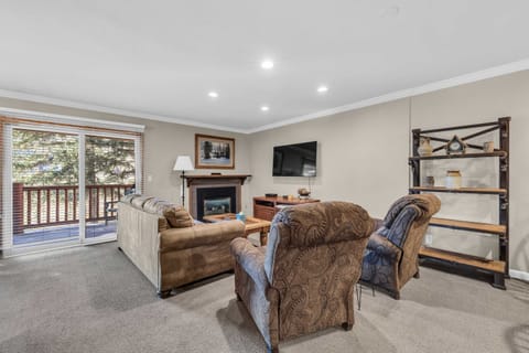 Living Room: Couch w/pull out bed, 2 recliners, gas fireplace, 65” Smart TV, access to balcony