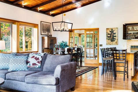 The great room with the comfy couch and the 8 person dining table and eat in kitchen!