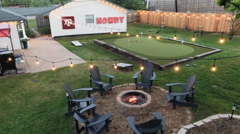 Relax under the string lights while enjoying the fire pit, putting green, and outdoor games in the huge fenced backyard.