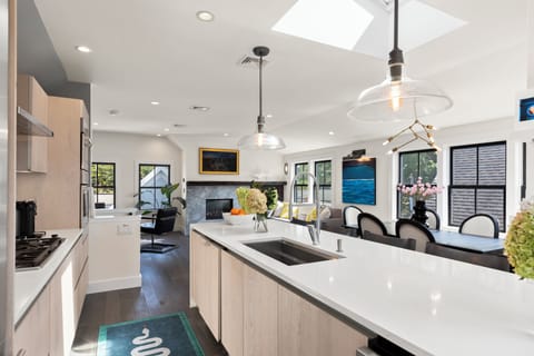 Enter this sleek, modern kitchen filled with natural light, perfect for cooking.