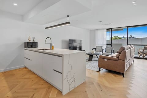 The oversized island doubles as a dining area for four, making meal preparation and dining both convenient and enjoyable.