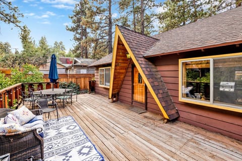 Private outdoor deck with a BBQ, surrounded by tall pines, perfect for relaxing under the trees after a day of adventure—enjoy peaceful forest views, fresh air, and a truly rejuvenating stay.