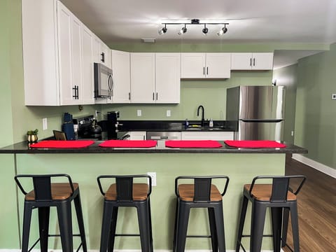 Eat in kitchen with bar seating and open floor plan.