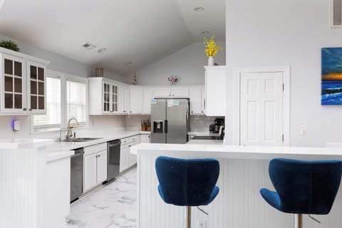 Fully Stocked Kitchen w/ Dishwasher, Oven, Microwave, Refrigerator, Ice Machine, Sink, and Breakfast Bar