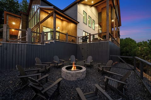 Outdoor fire pit area with Adirondack chairs and glowing fire—ideal for evening chats under the stars.