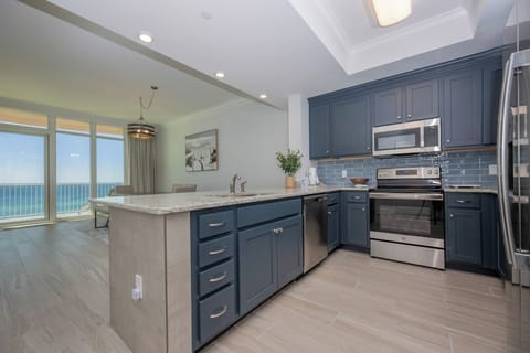 Prepare meals in this kitchen with elegant cabinetry, stainless appliances, and spacious countertops