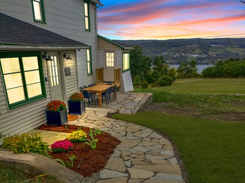 Enjoy sweeping lake views and stunning sunsets from our beautiful front walk and patio. This welcoming outdoor space sets the tone for your stay, offering a peaceful place to gather, sip morning coffee, or unwind after a day of exploring Watkins Glen. 