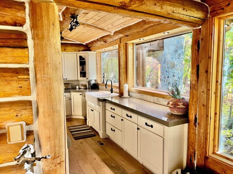 Chefs kitchen with large custom granite island just off the great room