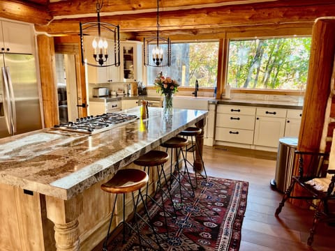 Chefs kitchen with large custom granite island just off the great room