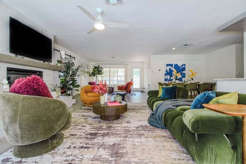 Living room with TV, plush couches, and beautiful ambience