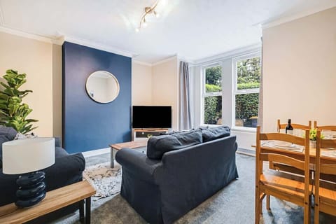 Relax in the downstairs lounge, complete with two sofas and a large internet-connected TV
