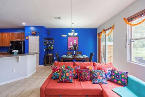 Relax in the vibrant Encanto and Coco-themed living room with plenty of space for everyone to enjoy.