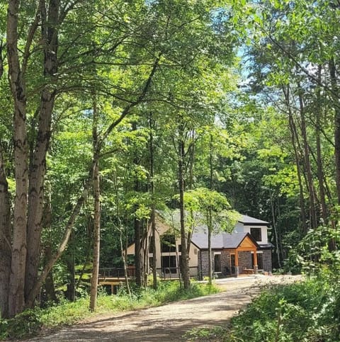 A peaceful woodland retreat tucked at the end of a private drive 🌲✨ — where modern comfort meets serene forest views for the ultimate Hocking Hills escape 🏡🌿