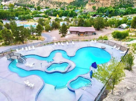 Upper pool area with a lazy river, swimming pool, two hot tubs, and nearby guest laundry for added convenience during your East Zion Resort stay.