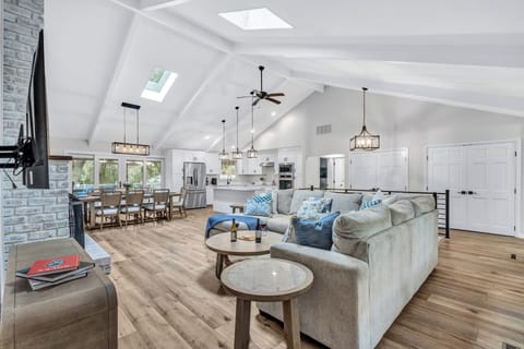 Sunlight dances through the expansive windows, casting a warm glow on the inviting interiors.