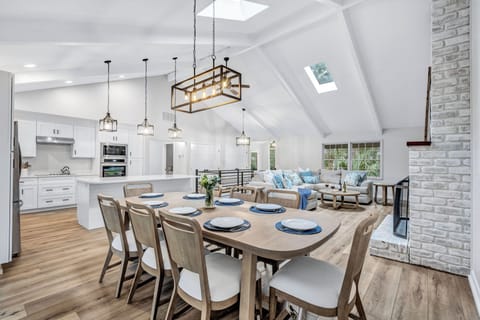Open floor concept connects the living and dining area with the kitchen, seemingly flowing further to the expansive outdoor deck.