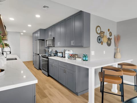 Fully stocked kitchen stainless steel appliances, & expansive dining table. 