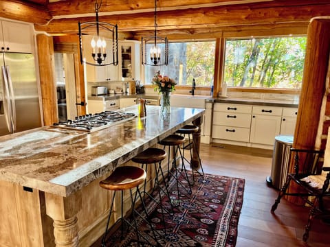 Chefs kitchen with large custom granite island just off the great room